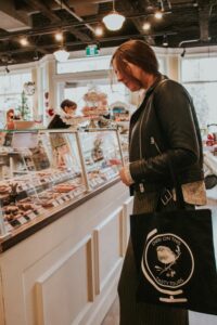 woman looking at chocolate shop selections