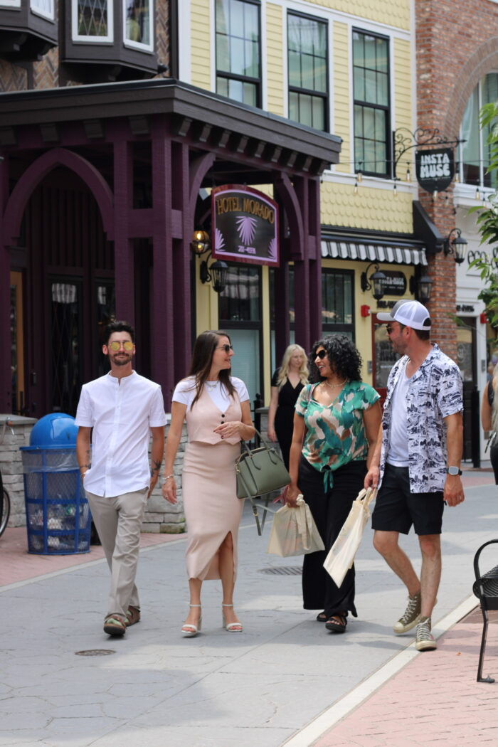 a group of people walking on a sidewalk