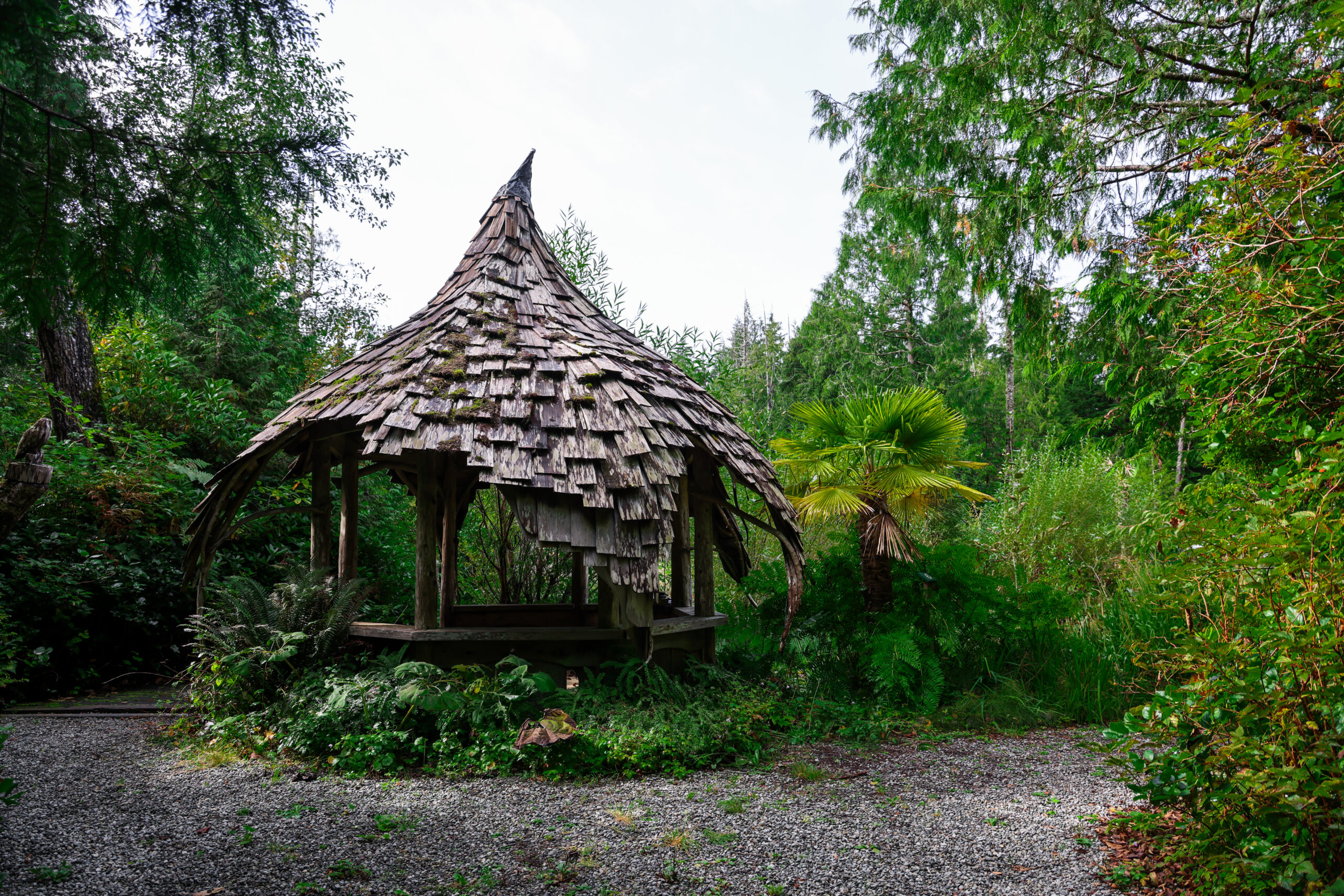 a wooden gazebo in the woods