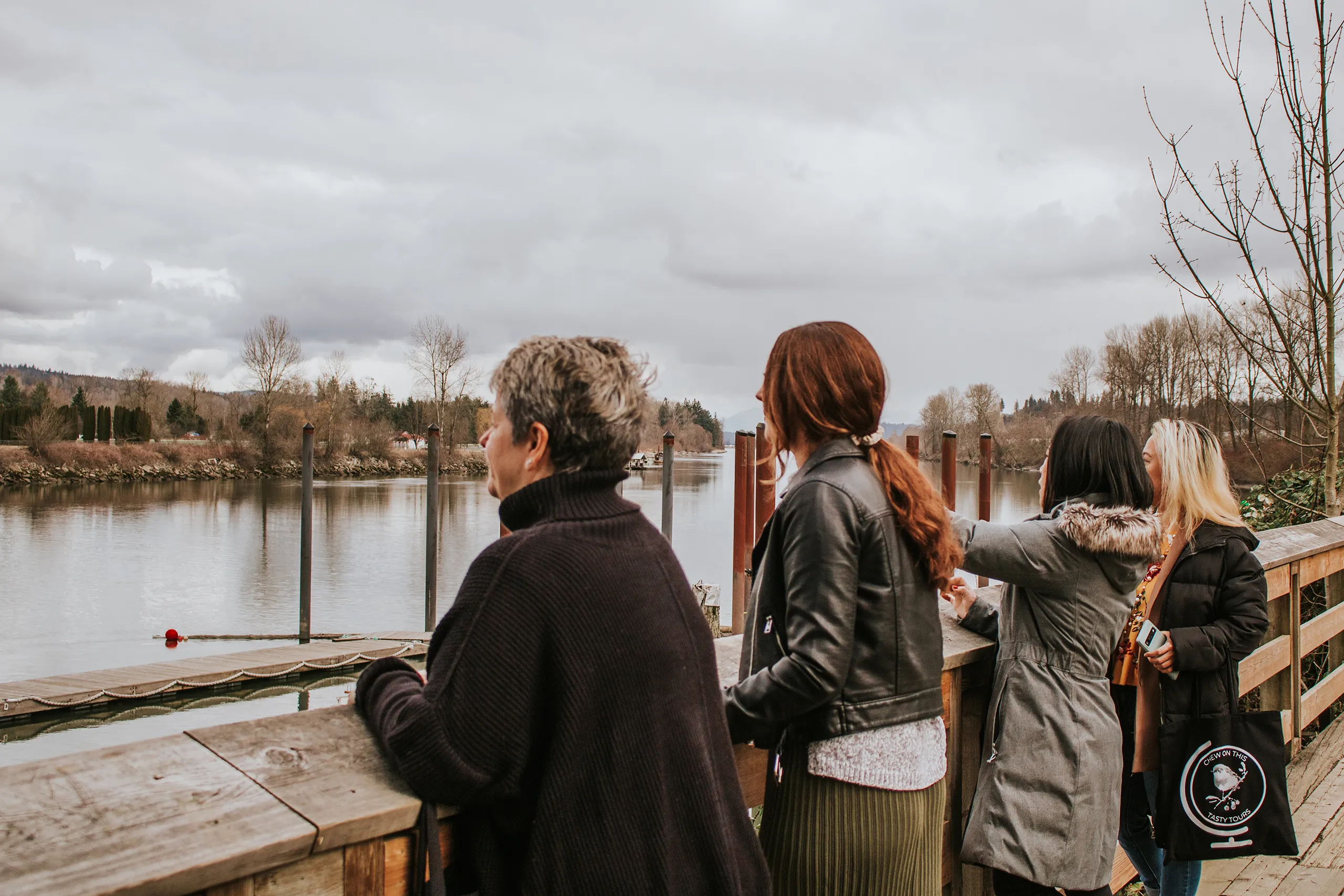 Four women on a Tasty Tours taking in the views of a waterway.