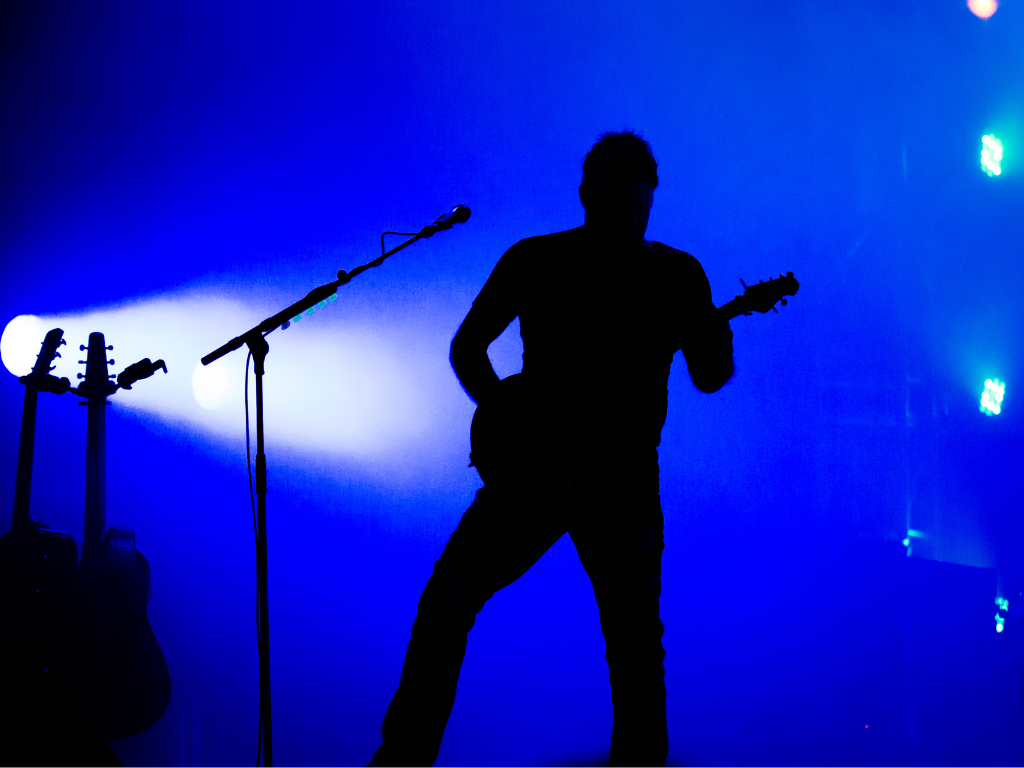 silhouette guitarist against blue background