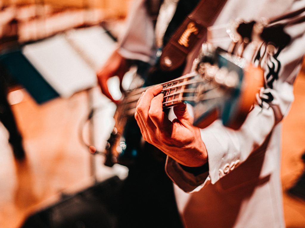 close up of a person playing a guitar